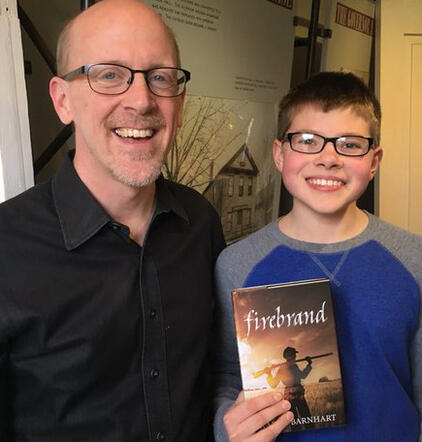 Aaron with young reader of Firebrand